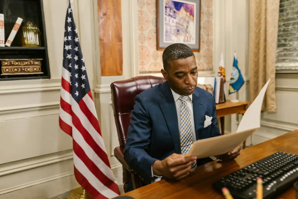 A professional man in a law office reads a document, symbolizing focus and diligence.